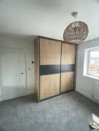 Oak Panel doors with a graphite grey strip in charcoal frames (angled view), fitted in Skelton